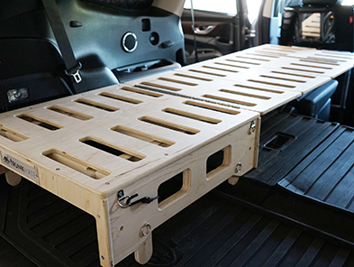 Expandable frame for car with wooden board bed, providing dual use as a sleeping surface and luggage rack