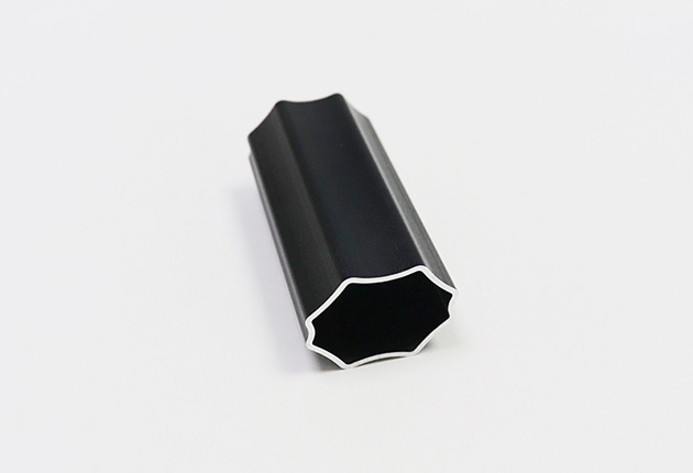 Black anodized aluminum circle with custom irregular shape for industrial or decorative use
