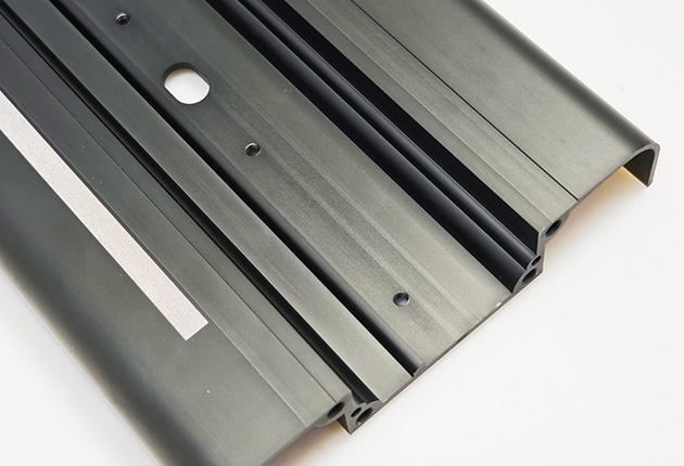CNC machined aluminum profile with brown anodized surface finish for precision applications