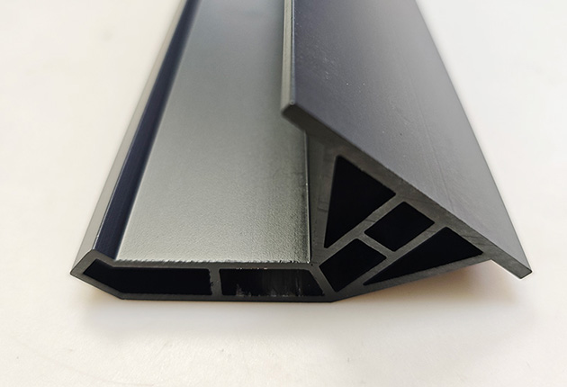 Custom black anodized aluminum profile close-up