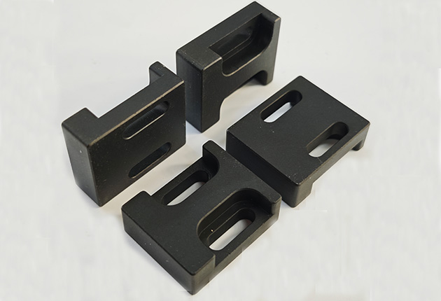 Custom black laser-cut aluminum part close